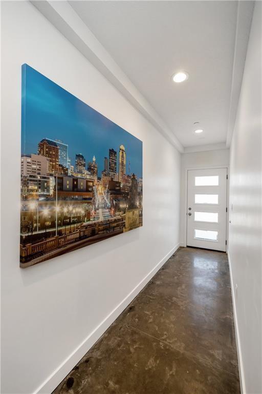508 Indianola Rd Unit 1, Des Moines, IA 50315 - hall with baseboards, a city view, concrete floors, and crown molding
