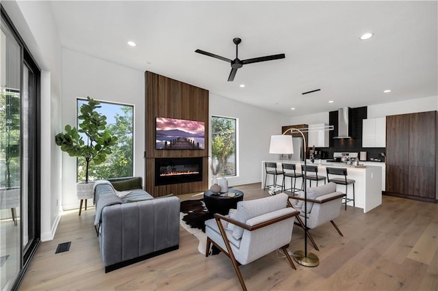 508 Indianola Rd Unit 1, Des Moines, IA 50315 - living room featuring visible vents, recessed lighting, light wood-type flooring, a large fireplace, and a ceiling fan