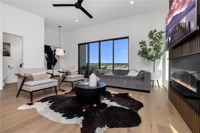 508 Indianola Rd Unit 1, Des Moines, IA 50315 - living area featuring recessed lighting, light wood-style flooring, a glass covered fireplace, and ceiling fan