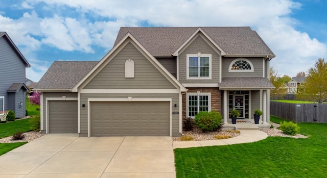 4208 SW Camden Ridge Dr, Ankeny, IA 50023 - view of front facade with driveway, a shingled roof, a garage, and stone siding