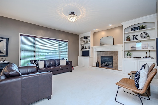 4208 SW Camden Ridge Dr, Ankeny, IA 50023 - carpeted living area featuring plenty of natural light, a fireplace, and built in shelves