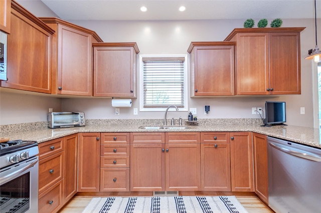 4208 SW Camden Ridge Dr, Ankeny, IA 50023 - kitchen with stainless steel appliances, a sink, recessed lighting, light stone counters, and light wood-style floors