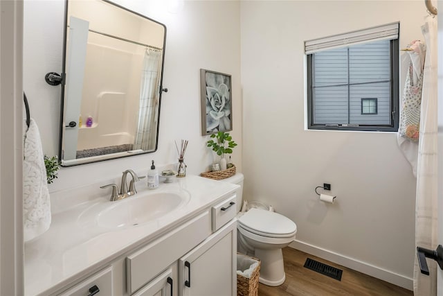 full bathroom with vanity, toilet, baseboards, wood finished floors, and visible vents