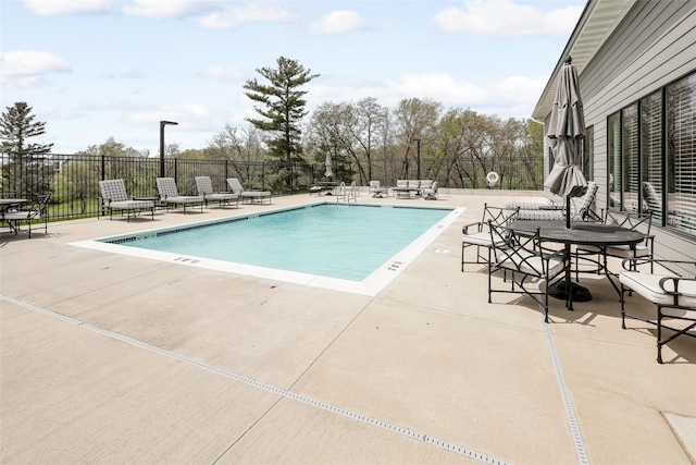 community pool featuring a patio and fence