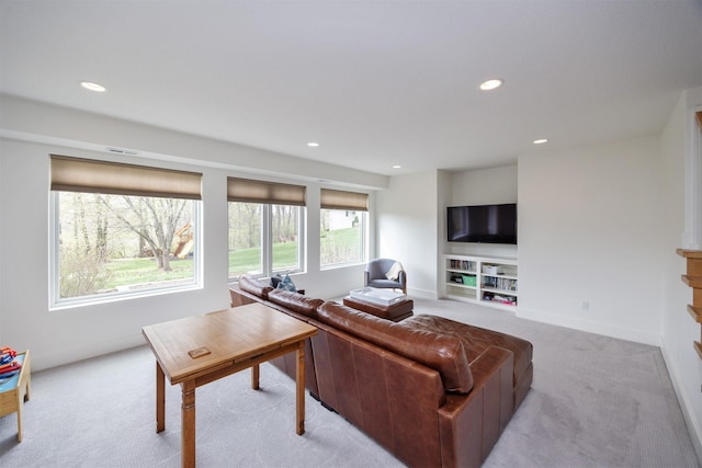 living room with baseboards, light carpet, and recessed lighting