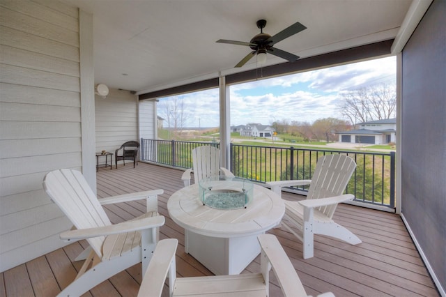 wooden deck featuring a residential view and ceiling fan