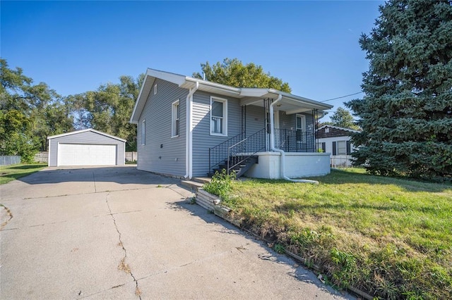 view of front of house with a porch, an outbuilding, a front lawn, and a garage