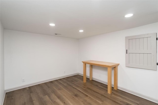 below grade area with baseboards, recessed lighting, wood finished floors, and visible vents