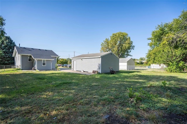 view of yard featuring fence and an outdoor structure
