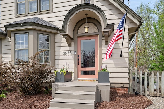 doorway to property featuring fence