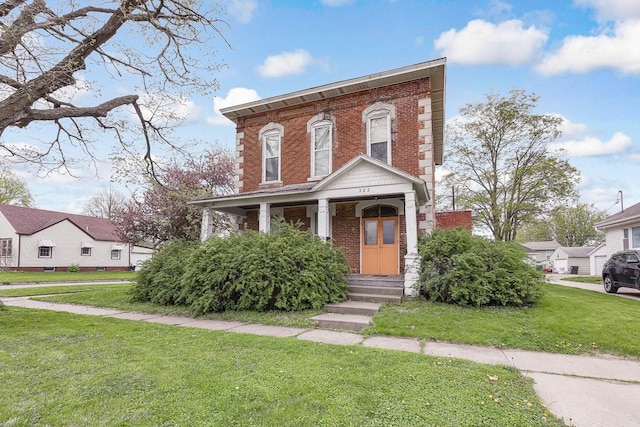 italianate-style house with brick siding and a front lawn