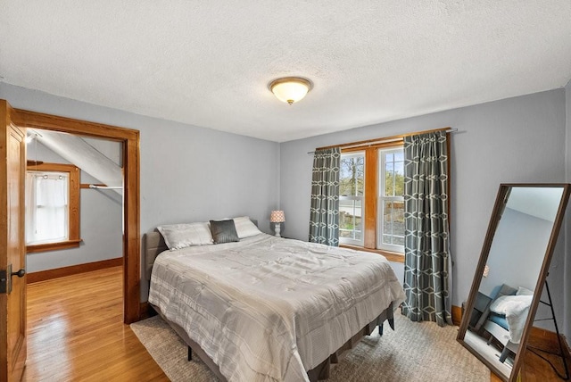 4714 Douglas Ave, Des Moines, IA 50310 - bedroom with baseboards, a textured ceiling, and wood finished floors