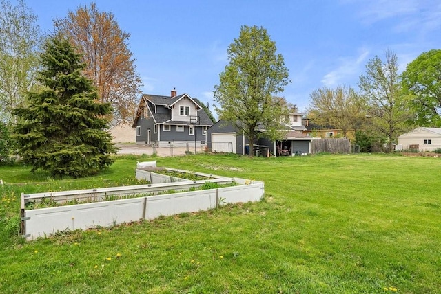 view of yard with fence and a garage