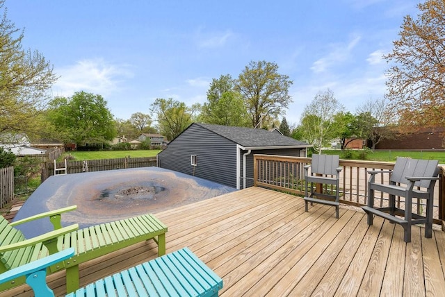 wooden terrace featuring a fenced backyard and a fire pit