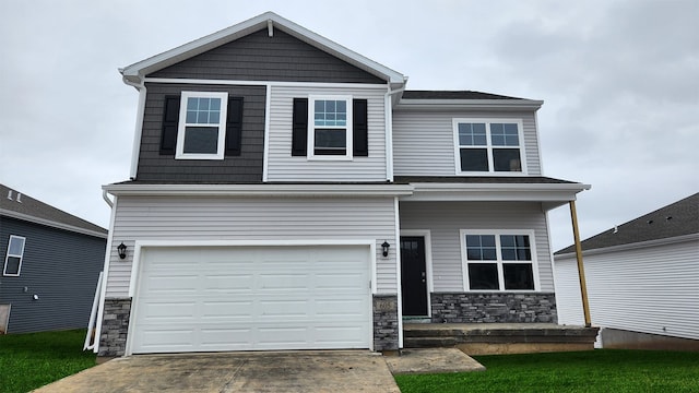 view of front of house with an attached garage, driveway, and stone siding