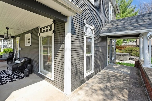 exterior space with a hot tub and a porch