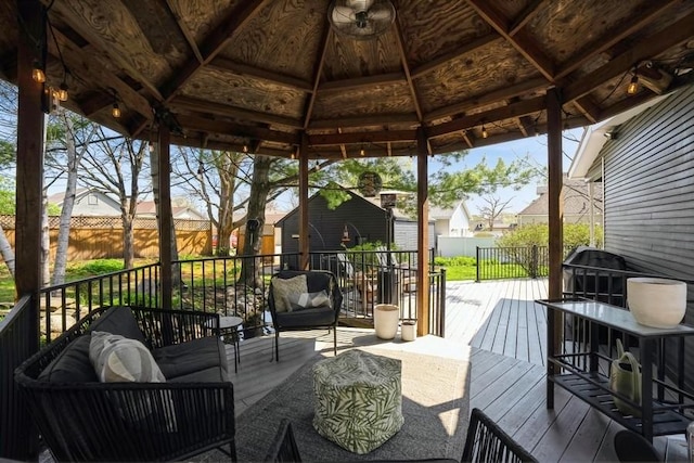 wooden deck with an outdoor hangout area, fence, a gazebo, and a residential view
