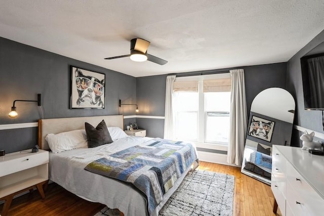 bedroom with light wood-style flooring and ceiling fan