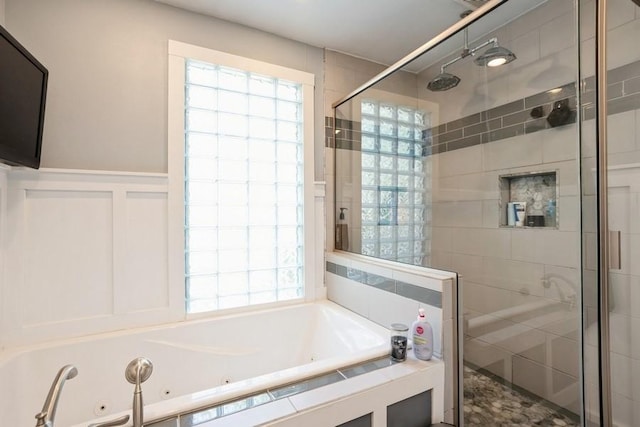 full bathroom with a healthy amount of sunlight, a jetted tub, and a stall shower