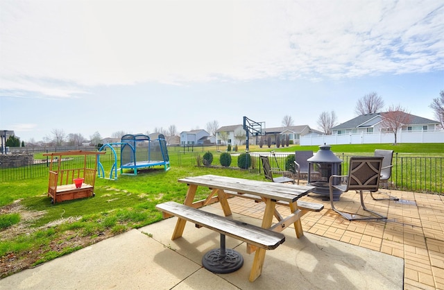 520 SE Murphy Dr, Waukee, IA 50263 - surrounding community with outdoor dining area, a fenced backyard, a patio area, a lawn, and a trampoline