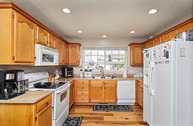 520 SE Murphy Dr, Waukee, IA 50263 - kitchen with a sink, recessed lighting, light wood finished floors, and white appliances