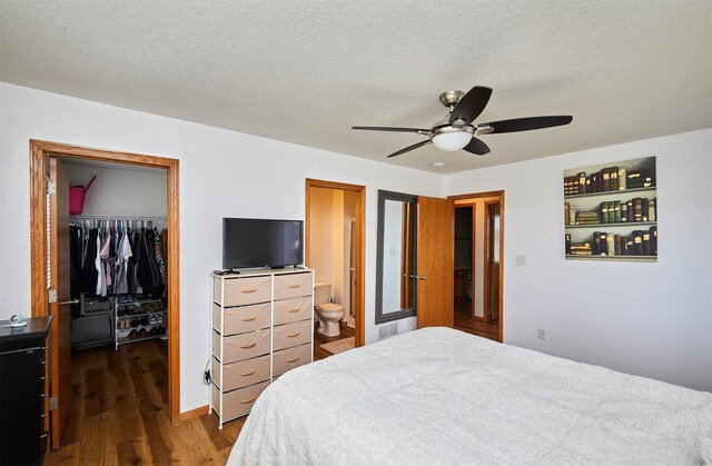 520 SE Murphy Dr, Waukee, IA 50263 - bedroom featuring a closet, dark wood-type flooring, a textured ceiling, a spacious closet, and ensuite bath