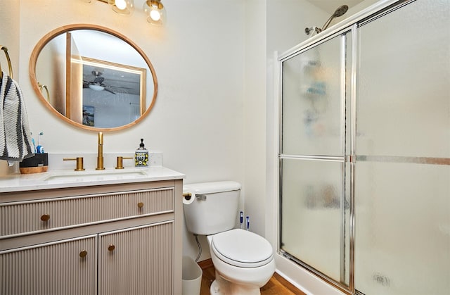 520 SE Murphy Dr, Waukee, IA 50263 - full bath featuring vanity, ceiling fan, a stall shower, and toilet