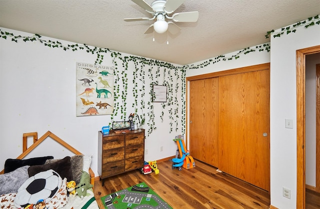 520 SE Murphy Dr, Waukee, IA 50263 - bedroom with baseboards, a textured ceiling, and wood finished floors