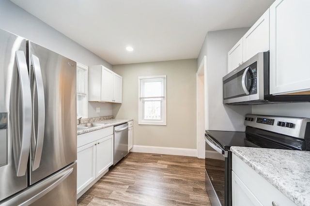 kitchen featuring a sink, white cabinets, and stainless steel appliances