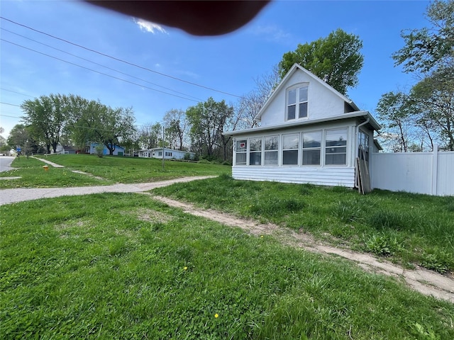 2104 23rd St, Des Moines, IA 50310 - view of property exterior featuring fence, a lawn, and a sunroom