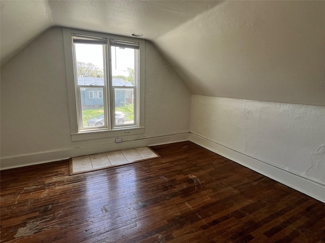 2104 23rd St, Des Moines, IA 50310 - bonus room featuring baseboards, hardwood / wood-style floors, and lofted ceiling