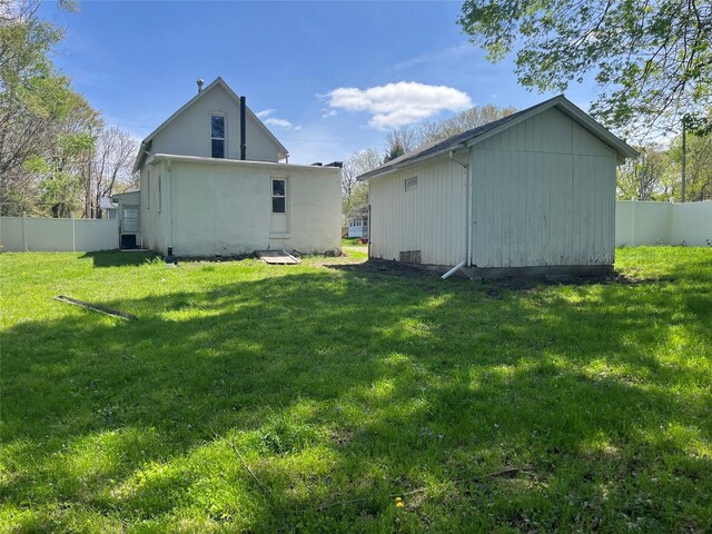 2104 23rd St, Des Moines, IA 50310 - rear view of house with a lawn, fence, and an outbuilding