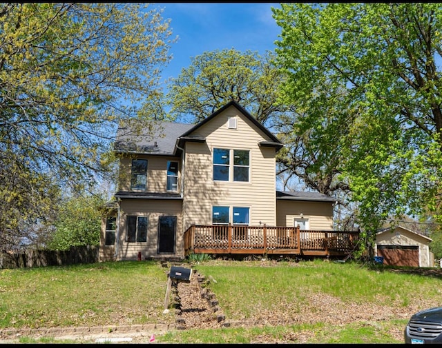 rear view of property with a yard and a wooden deck