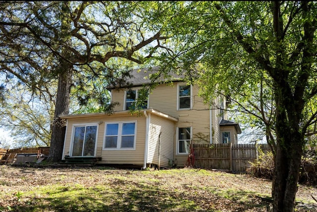 back of house featuring fence and entry steps