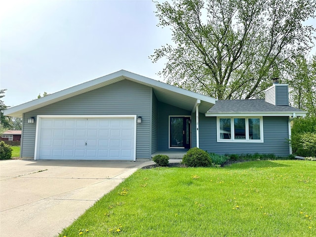 view of front of house with driveway, a chimney, a front yard, and a garage