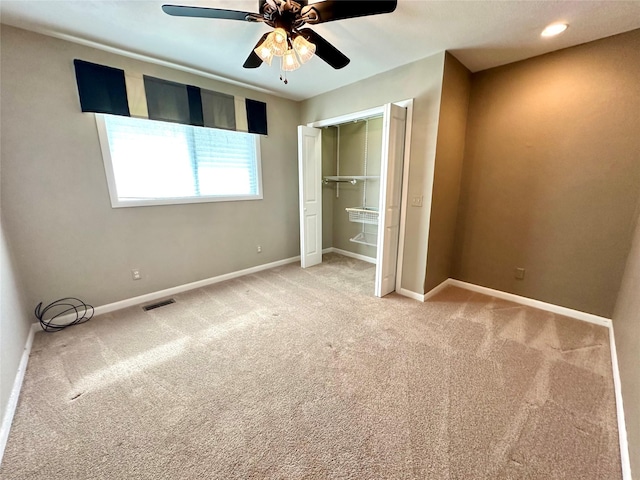 unfurnished bedroom with carpet floors, baseboards, a closet, and visible vents