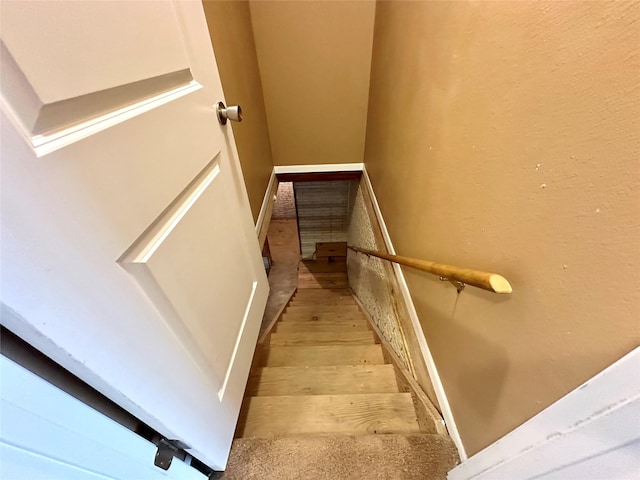 stairway with wood finished floors