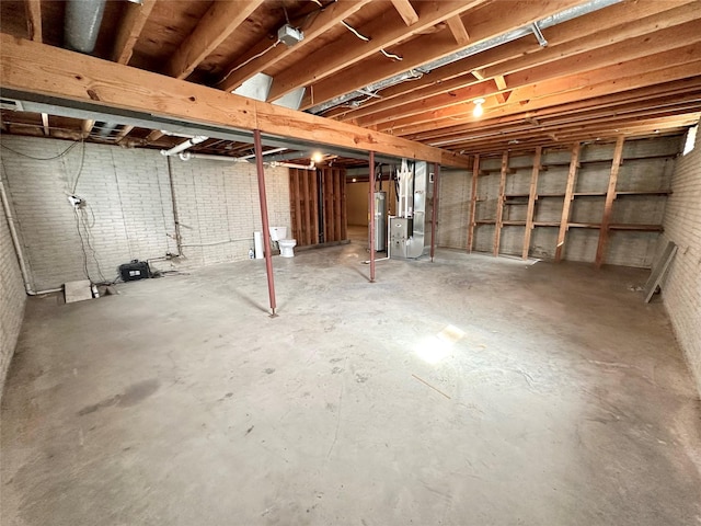unfinished below grade area featuring heating unit and water heater