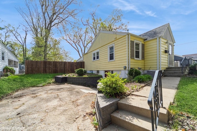 view of home's exterior featuring fence