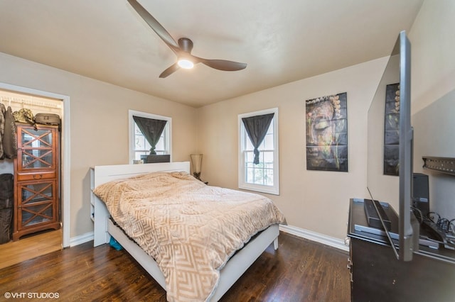 bedroom featuring baseboards, a ceiling fan, and wood finished floors