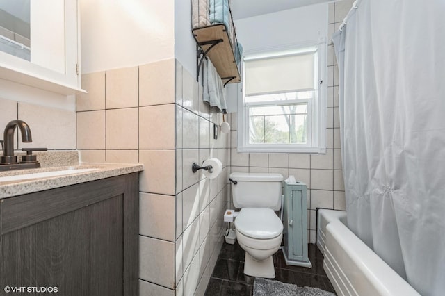 full bathroom with vanity, shower / bathtub combination with curtain, toilet, and tile walls