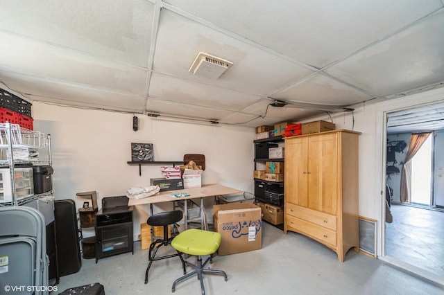 home office featuring visible vents and concrete flooring