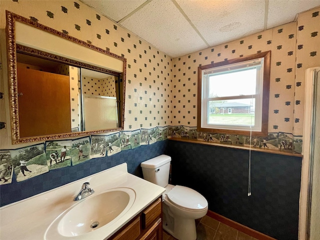 full bathroom with tile patterned flooring, vanity, toilet, wallpapered walls, and a stall shower