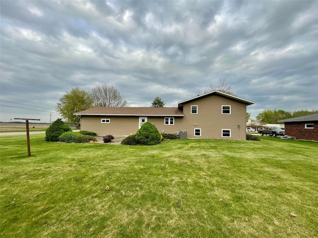 back of property featuring a yard