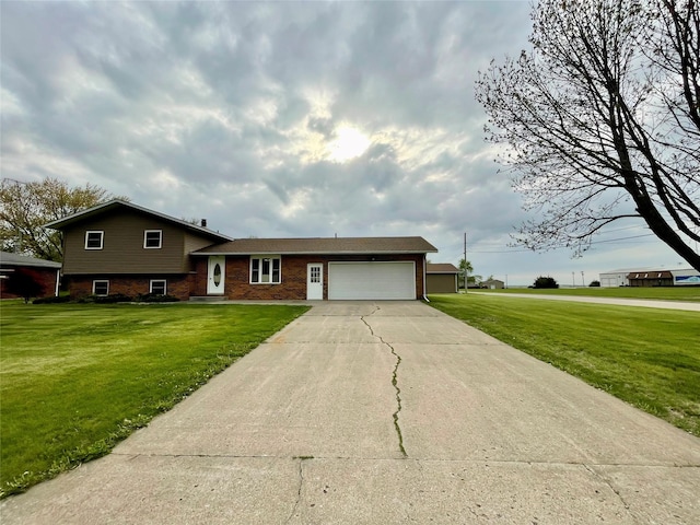 split level home with brick siding, driveway, a front yard, and a garage