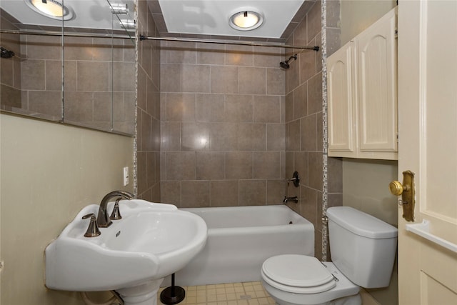 full bathroom featuring toilet, bathing tub / shower combination, and a sink