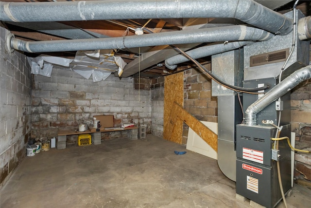 unfinished below grade area featuring heating unit