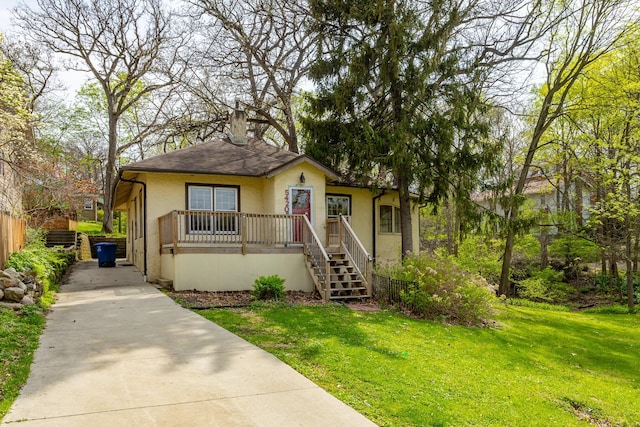 bungalow-style house with a chimney, a front yard, fence, concrete driveway, and stucco siding