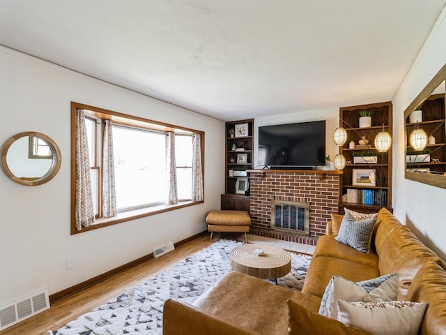 living room with visible vents, baseboards, and wood finished floors