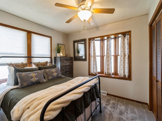 bedroom featuring dark colored carpet, a ceiling fan, baseboards, visible vents, and a closet